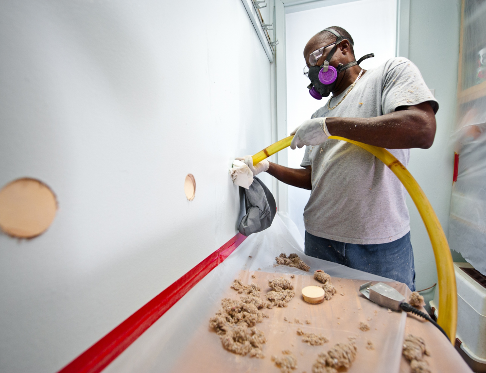 man installing insulation